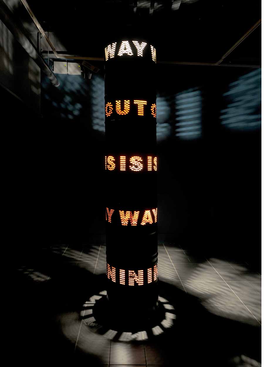 Liliane Lijn, Way Out is Way In, 2009. Painted steel solvent drums, 3 phase motor, inverter, programmed speed, direction control chip and halogen lighting, 300 x 60 cm. Photo: Liliane Lijn.